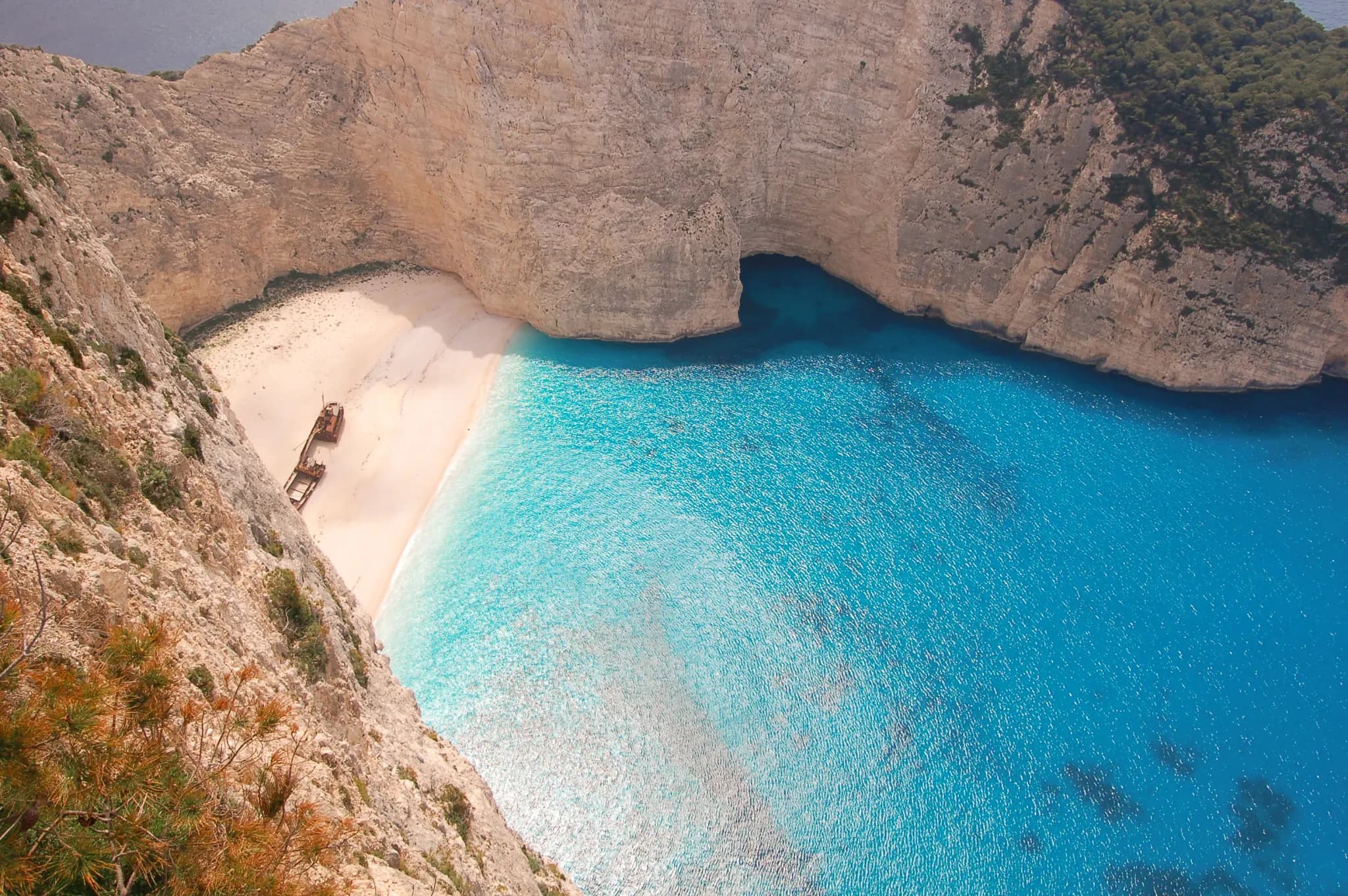Navagio (Shipwreck) Beach in Zakynthos — turquoise water and white sand framed by towering cliffs